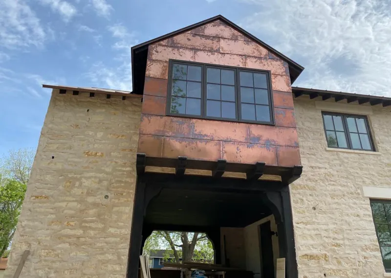 Copper metal panel facade on a stone building for Roof Repair in North Fair Oaks
